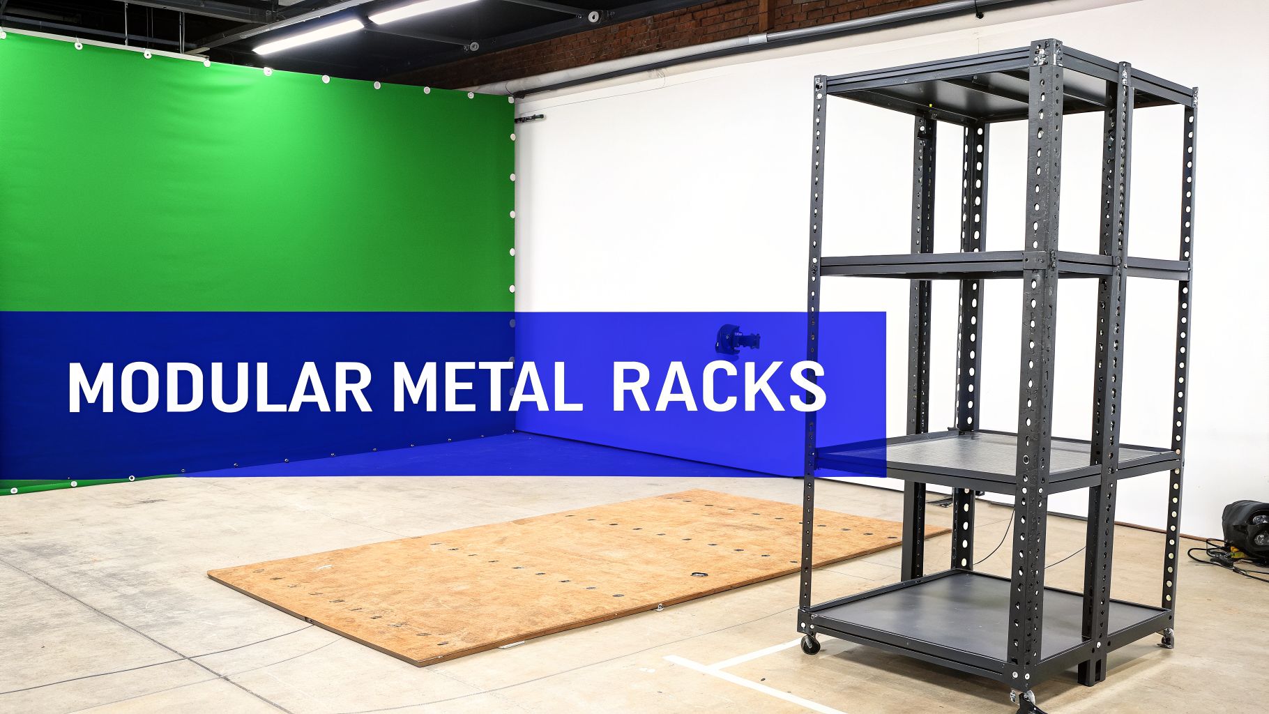 Black modular metal rack on wheels in a studio with a green screen and a wooden platform.