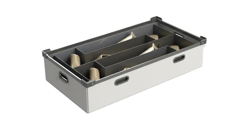 A white and grey corrugated plastic storage box with internal dividers holds several light brown shoe trees.